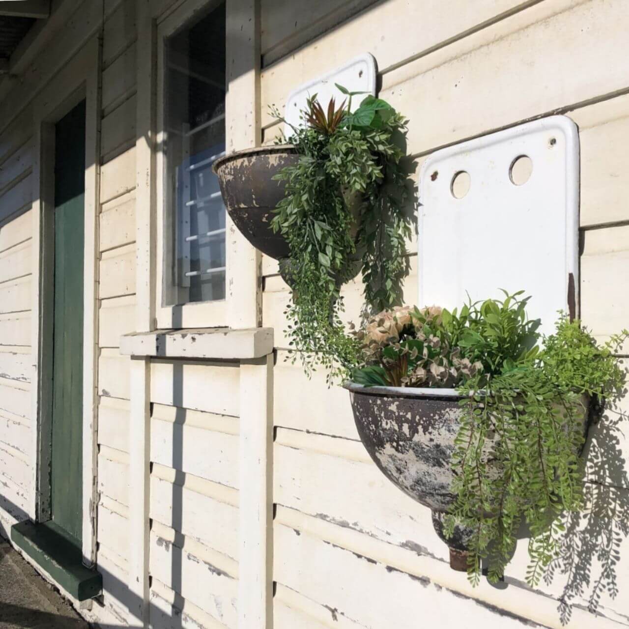 Antique wall fountains with herbs and flowers growing 