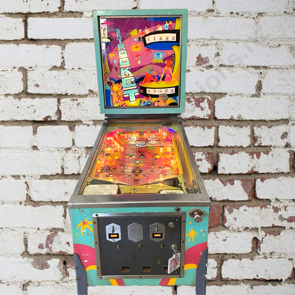 Size 56cm Long x 1.32m Wide x 1.79m High. This is a really rare unit - only 545 confirmed units were made at the time. This is the only known one in New Zealand. This is an electromechanical game - it has the mechanical score reels and the lovely traditional bells and chimes of the time Timeless! This game has some really cool features - you shoot shots to lock in the value of the moving skyrockets, and then shoot these holes here to collect the skyrocket value. These targets here will start the skyrockets 