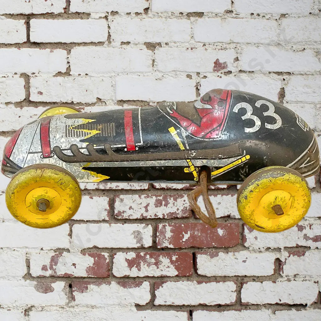 Size 17cm Long x 9cm Wide x 7cm high. Made in Panmure, Auckland by Lincoln Toys, tin plate lithogrpahed, wind up. Condition good.