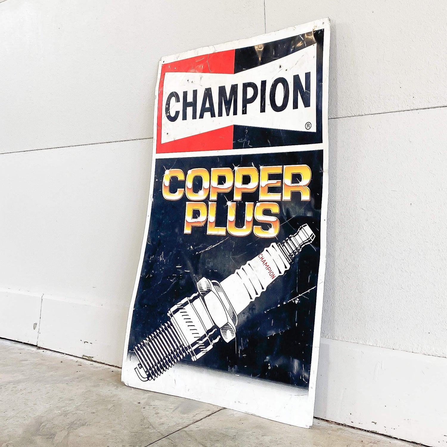 A Champion Spark Plugs Sign