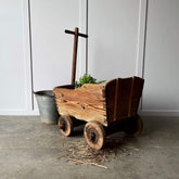 a wooden pull along antique cart
