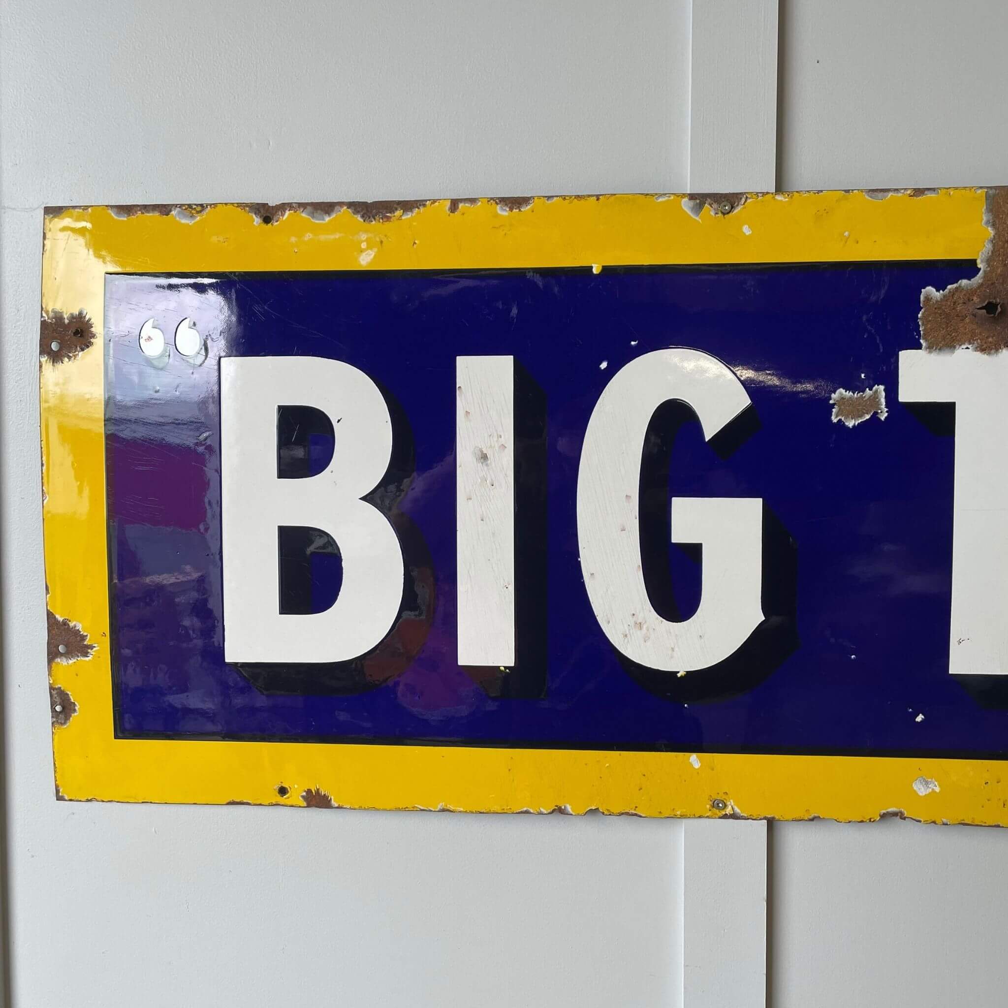 Blue and yellow enamel sign
