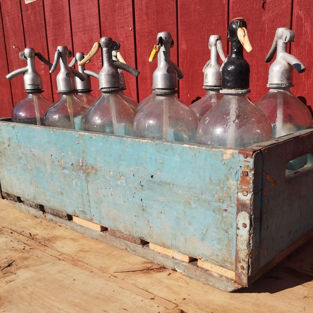 Soda syphons in crate