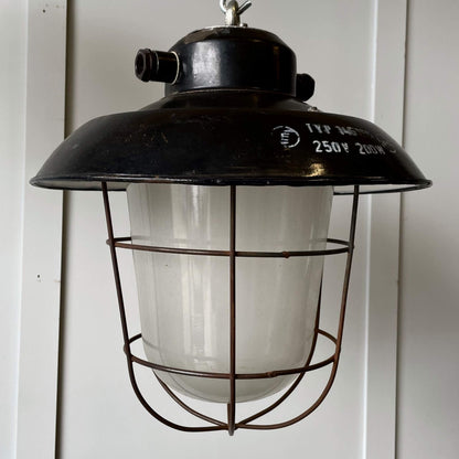 Vintage industrial lighting with black enamel, frosted glass and a wire cage
